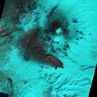 A landscape that looks eerie and remote is really Russia's Bezymianny volcano rendered in a false-color image. The volcano erupted on April 14, 2011. In this infrared photo, lava appears red on the summit and to the south-east. Bare rock and ash are gray