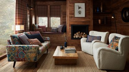 A living room with a fireplace and a floral wallpaper