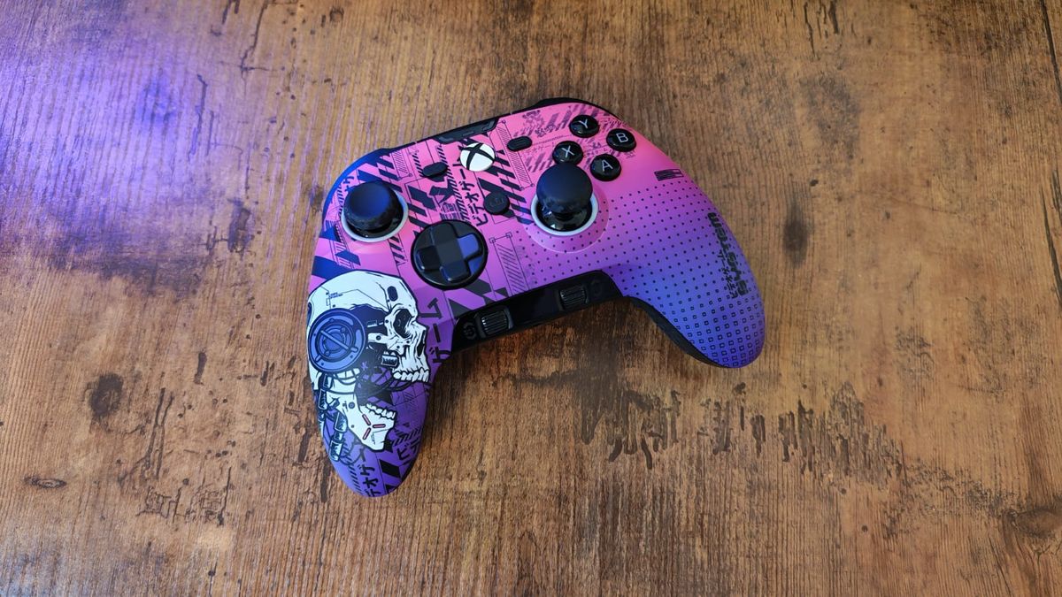 The blue and pink Respawn colorway of the Scuf Valor Pro Wireless on a wooden desktop