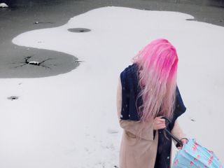 A lady with pink hair and umbrella