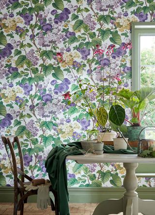 Bold floral wallpaper applied in a dining room