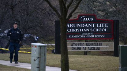 Police officer walks near Madison private school where shooting killed two plus shooter