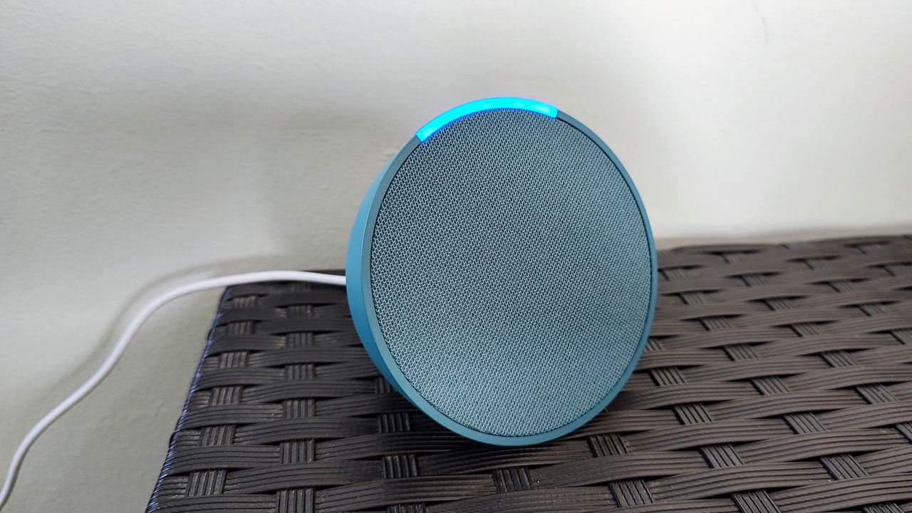 Amazon Echo Pop review: speaker in blue on a black shelf