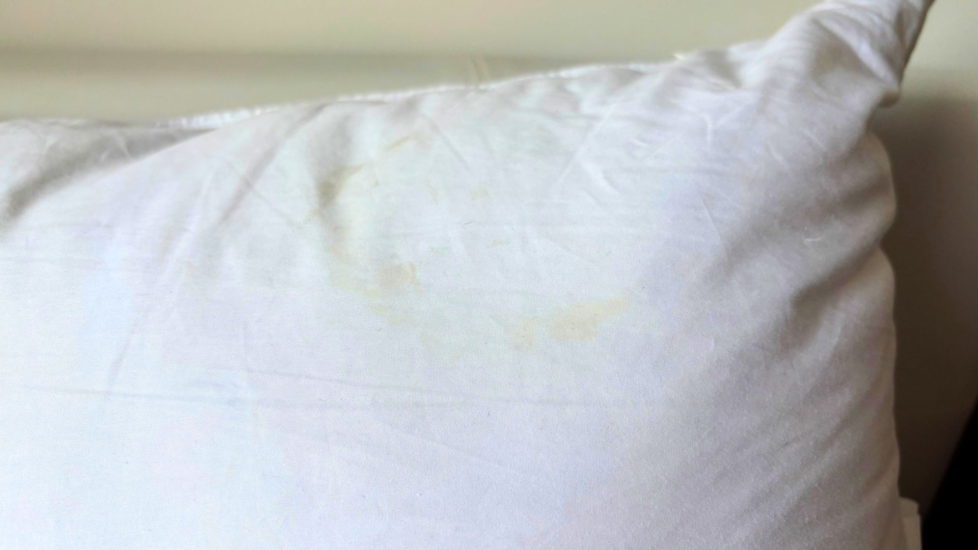 A pillow with a yellow retinol stain.