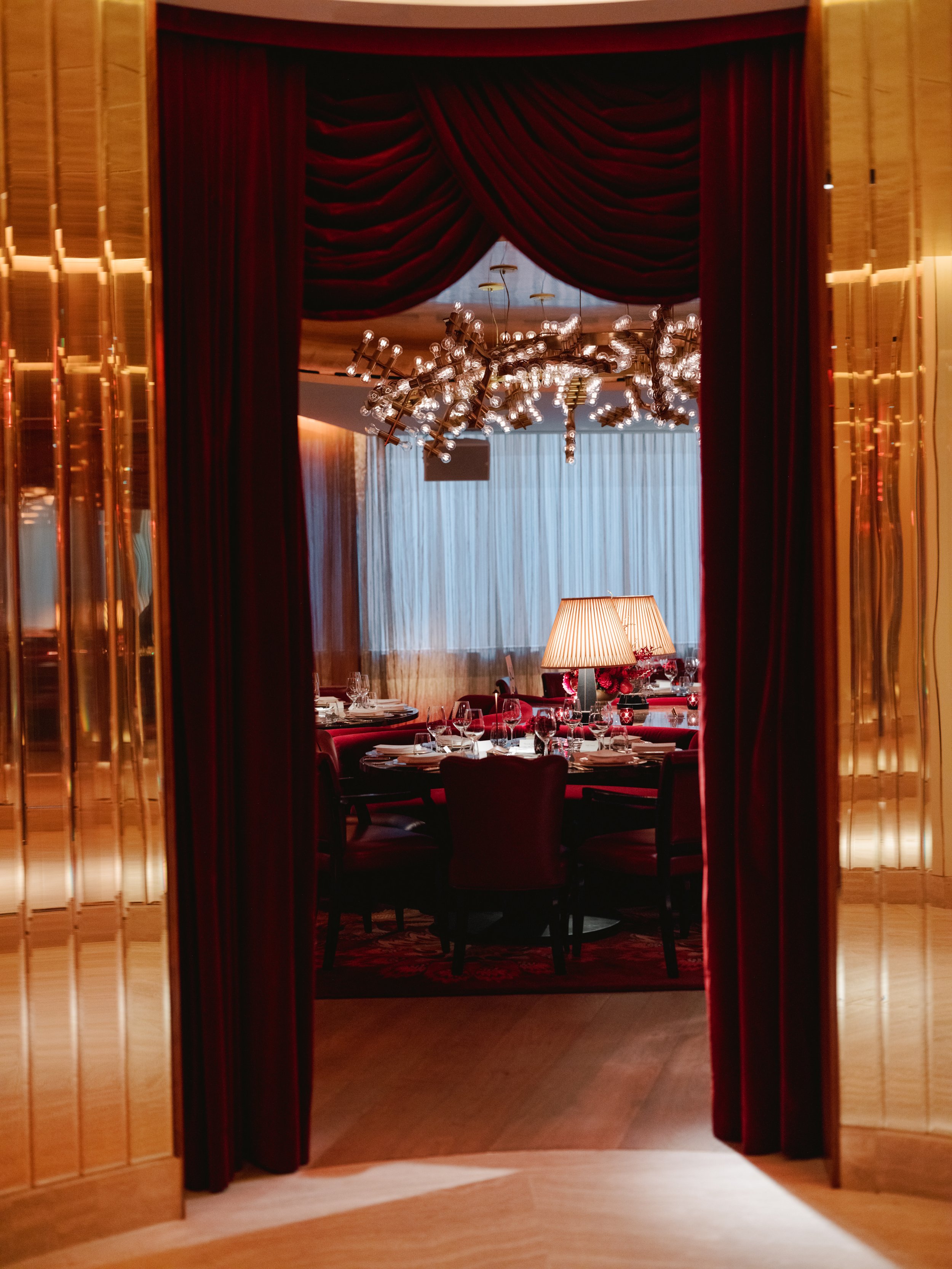 A spectacularly designed hotel&#039;s communal areas mix red, animal-print, or goldeny velvety fabrics with golden and brass surfaces, colourful artwork, theatrical chandeliers, and a retro-fuelled atmosphere.