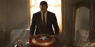 Sam Wilson/Falcon (Anthony Mackie) looks at Captain America&#039;s shield in The Falcon And The Winter Soldier