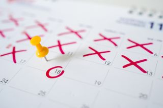 Calendar with yellow pins on the 18th. Yellow pins are the dates of the calendar or planner.