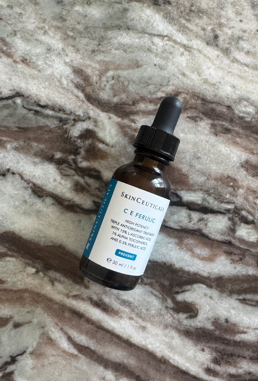 SkinCeuticals C E Ferulic vitamin C serum bottle on marble table