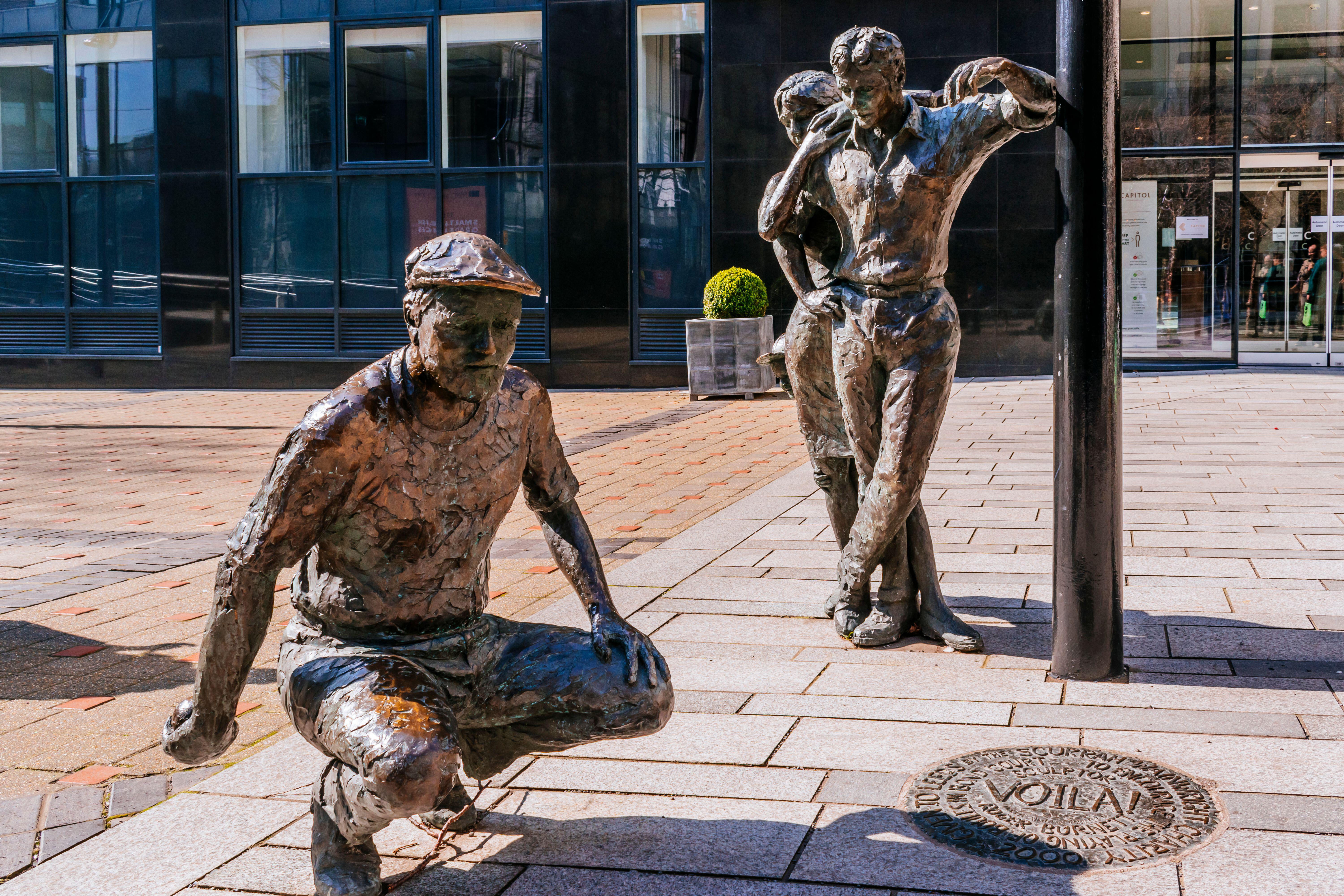A Statue of some men in leeds playing boules