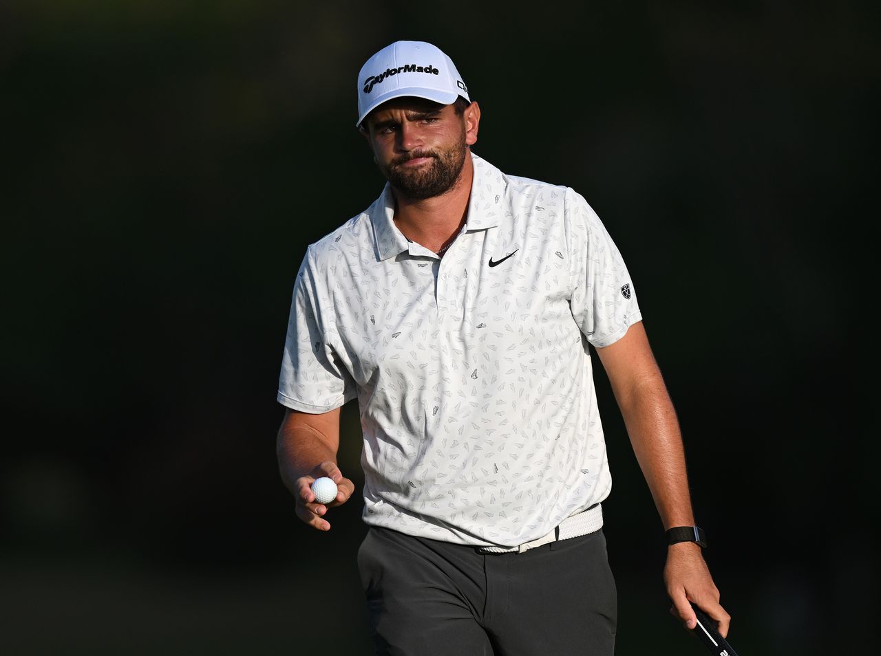 Casey Jarvis waves to the crowd holding a golf ball