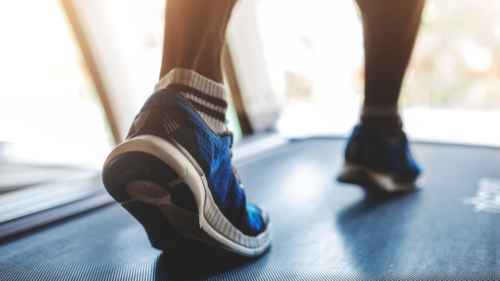 A close up of running shoes on a treadmill