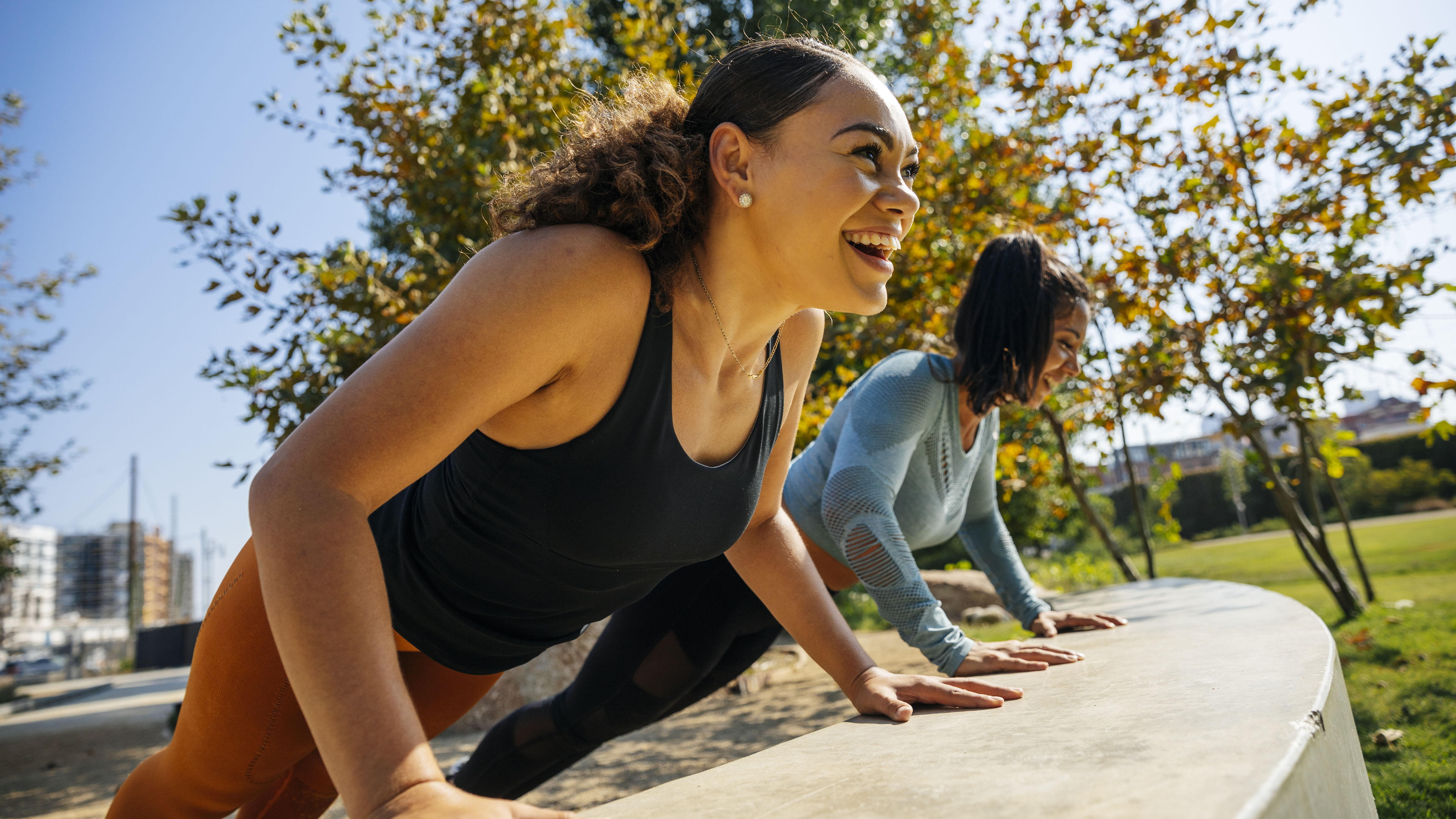 Women doing push-up 30 day fitness challenge outdoors