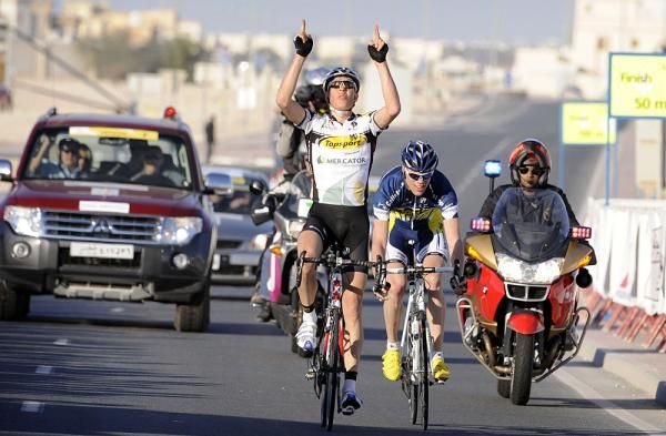 Geert Steurs remembers his fallen teammate Federiek Nolf, who died in his sleep during last year's race, as he crosses the line to win the second stage.