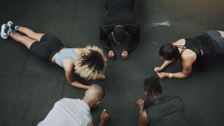 Group of people performing plank