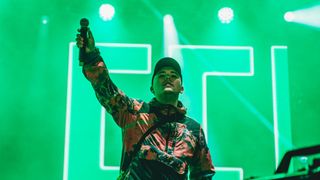 GLASTONBURY, ENGLAND - Mo Chara of Irish band Kneecap perform on the Woodies Stage during day four of Glastonbury Festival at Worthy Farm, Pilton. Founded by Michael Eavis in 1970, Glastonbury Festival features around 3,000 performances across over 80 stages. Renowned for its vibrant atmosphere and iconic Pyramid Stage, the festival offers a diverse lineup of music and arts, embodying a spirit of community, creativity, and environmental consciousness.