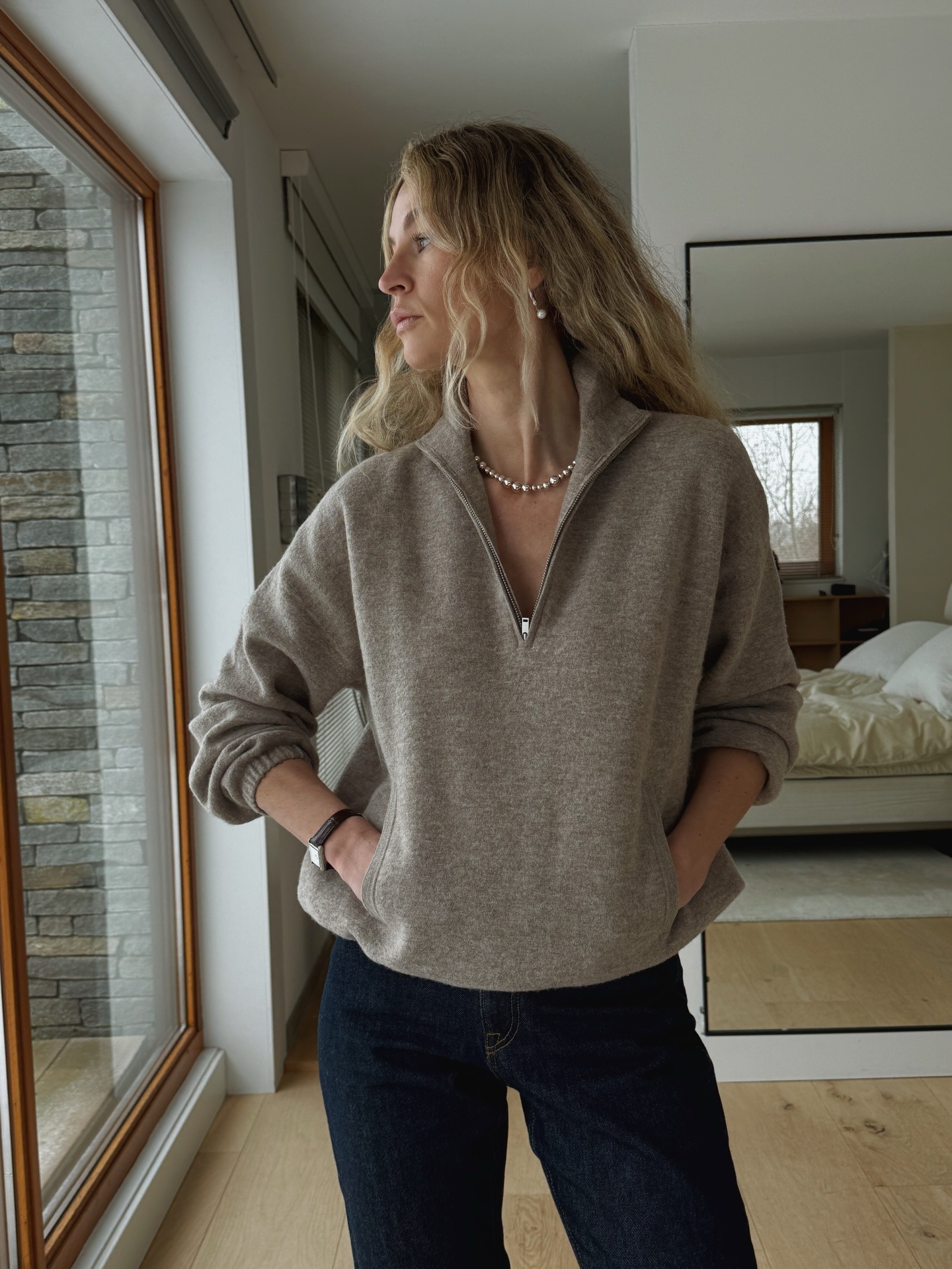 Influencer wearing quarter-zip-sweater outfit.