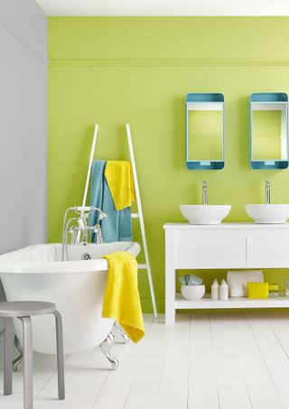 Bright white bathroom with lime green color block wall