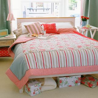bedroom colorful boxes with cushion and tray on bed