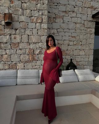 Woman wearing a burgundy crochet dress