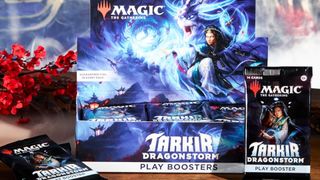 MTG Tarkir: Dragonstorm Play Booster box on a wooden table, with mist and cherry blossom in the background