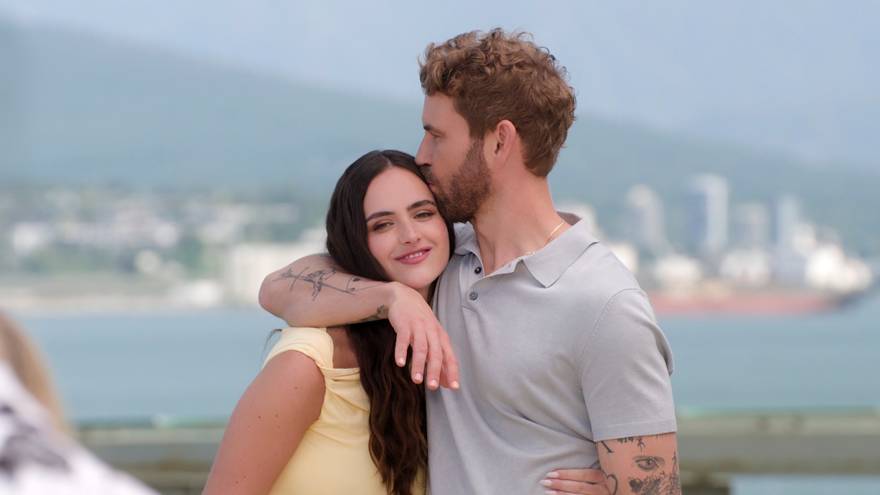 Nick Viall kisses his wife Natalie Joy on the head as they host the Netflix dating show Age of Attraction.