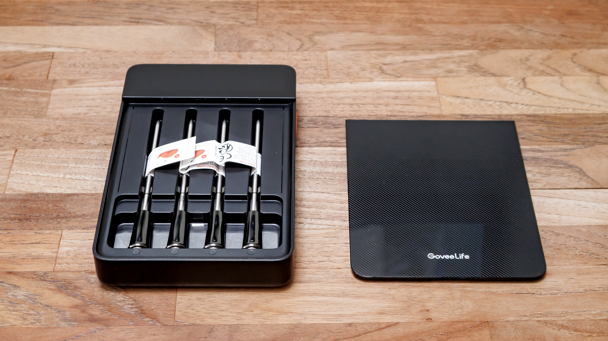 GoveeLife Smart Wireless Meat Thermometer on a kitchen surface and probes in the hub