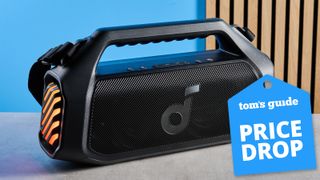 the soundcore boom 2 plus bluetooth speaker with orange LED lights and a tom's guide deal badge