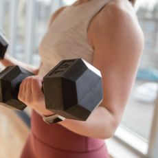 A woman performing bicep exercises, including bicep curls