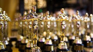 Oscars statuettes standing in a row