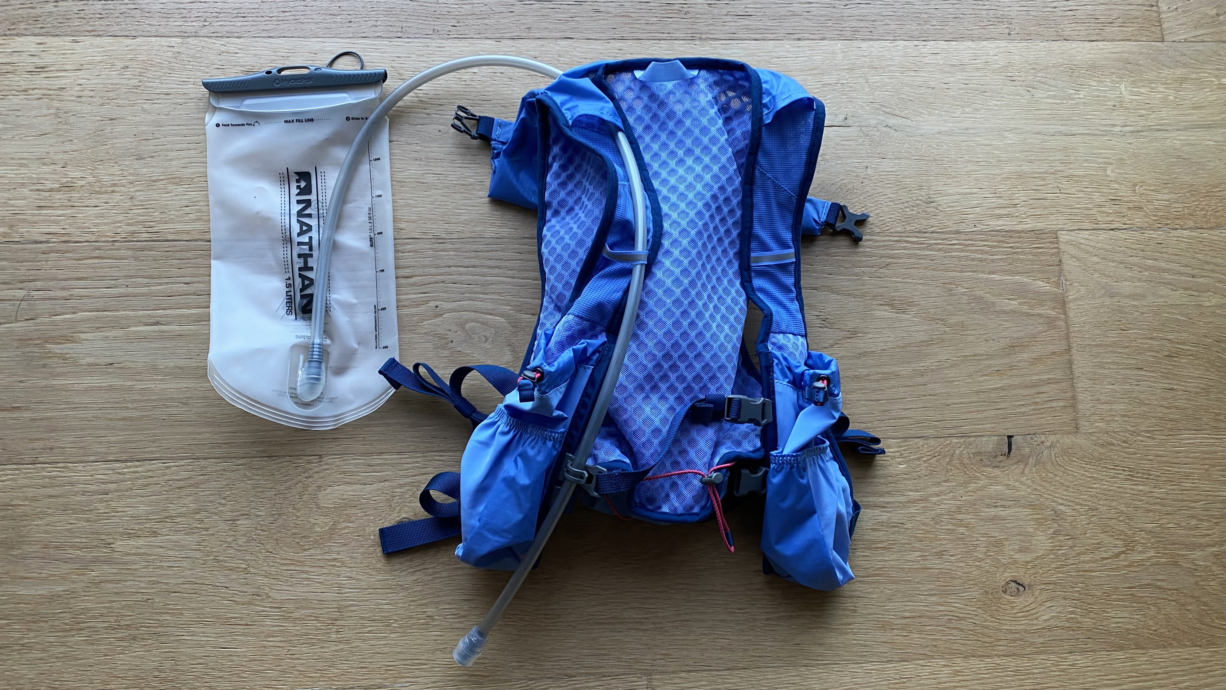 Nathan TrailMix 2.0 12L Hydration Pack laid out on floor