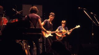 Members of American New Wave group Talking Heads perform onstage at the Park West, Chicago, Illinois, August 23, 1978. Pictured are, from left, Jerry Harrison and David Byrne, both on guitars, and Tina Weymouth, on bass.