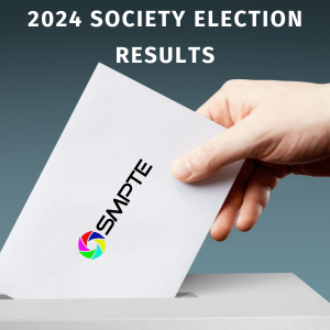 A hand placing a SMPTE ballot in a box.