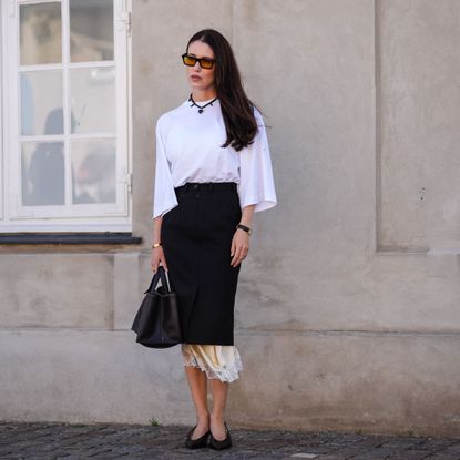 woman wearing white tee and black skirt