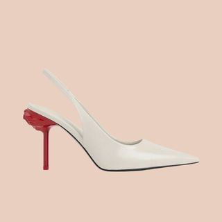 flat lay of white shoe with red heel