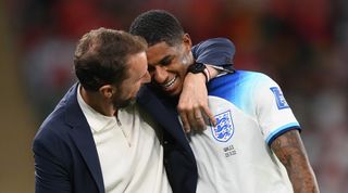 Marcus Rashford is hugged by England manager Gareth Southgate after being substituted against Wales in the 2022 World Cup in Qatar.