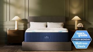 The DreamCloud hybrid mattress on a bed frame in a spacious bedroom