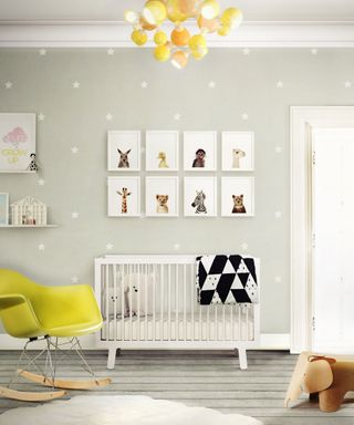 nursery with yellow armchair and framed animal prints on the wall