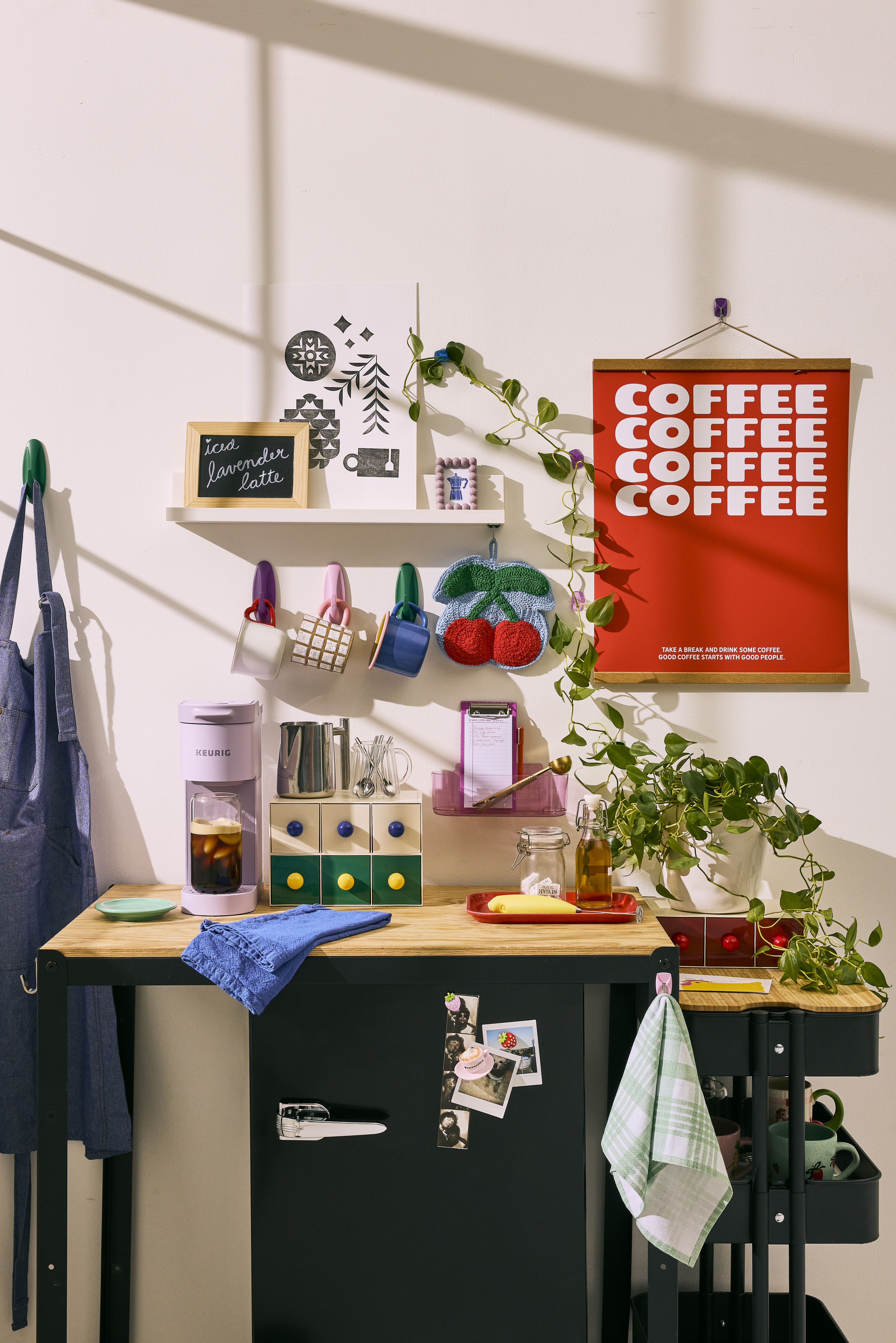 Dorm room kitchenette with colorful applianced and mugs mounted to the wall