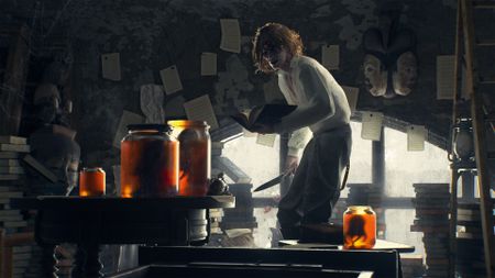 Corentin, a man with worms for eyes, holds a book in one hand and a knife in the other