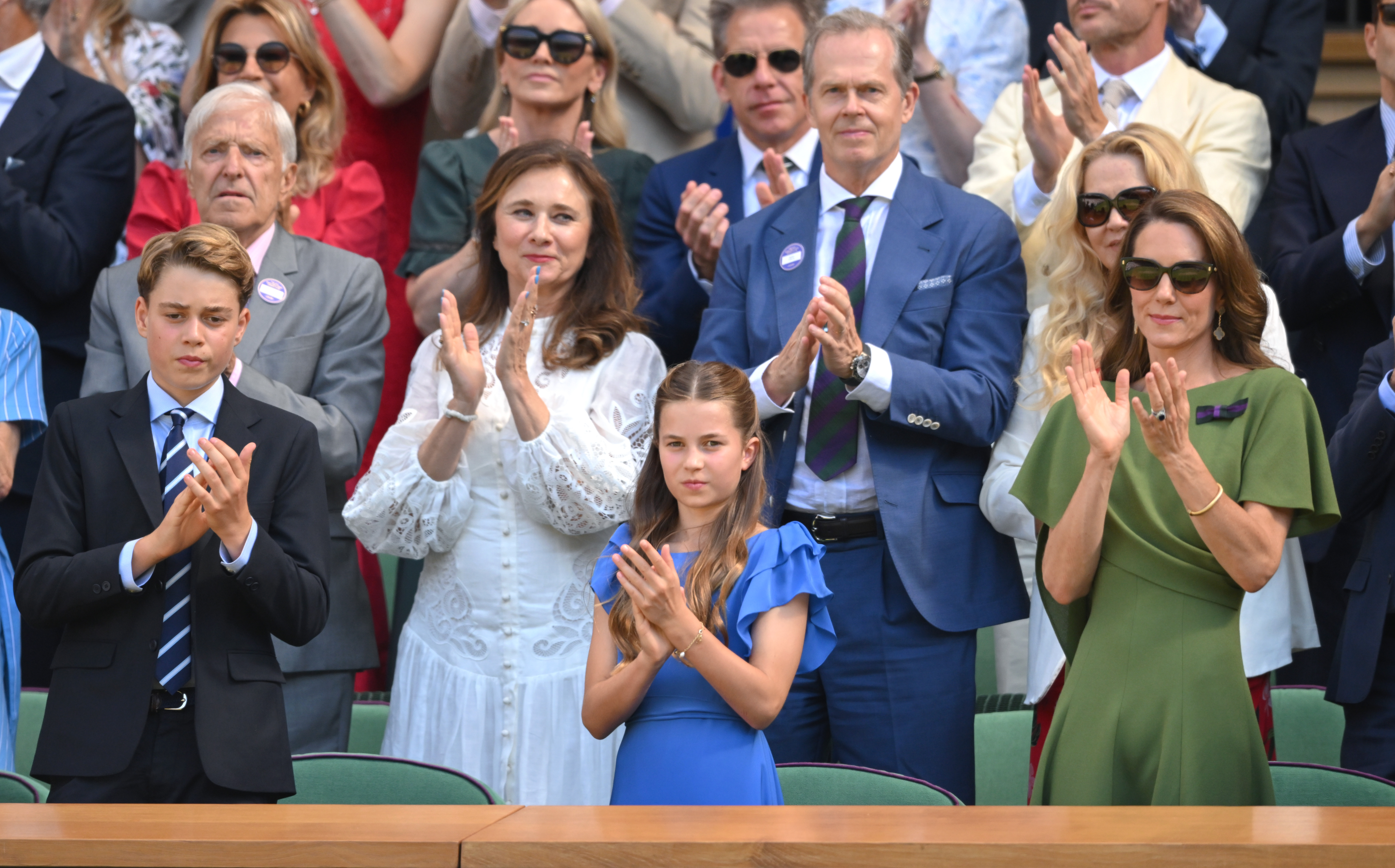 Prince George,Princess Charlotte and Princess Kate standing and clapping at Wimbledon