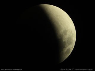 Photographer John W. Johnson of the Omaha Astronomical Society in Nebraska captured this view of the moon partially obscured by Earth's shadow during the total lunar eclipse of April 15, 2014. This image was captured from a live feed by the Virtual Telesc