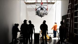 Hardware for NASA's SPHEREx mission lowered through the ceiling into test chamber.