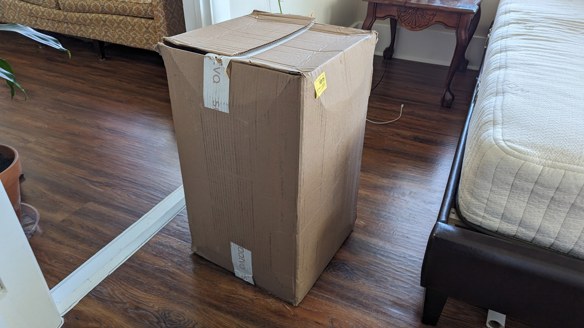 The Saatva Graphite Memory Foam Mattress Topper in its delivery box