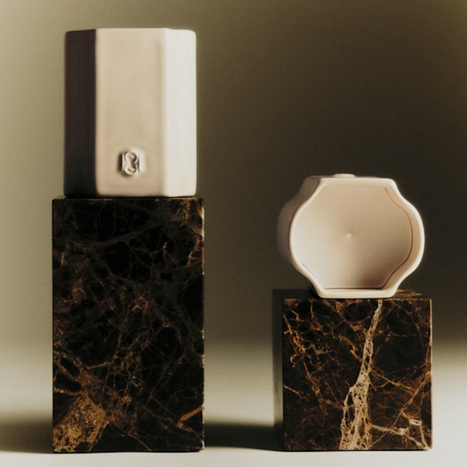 Two ceramic candles on stone blocks