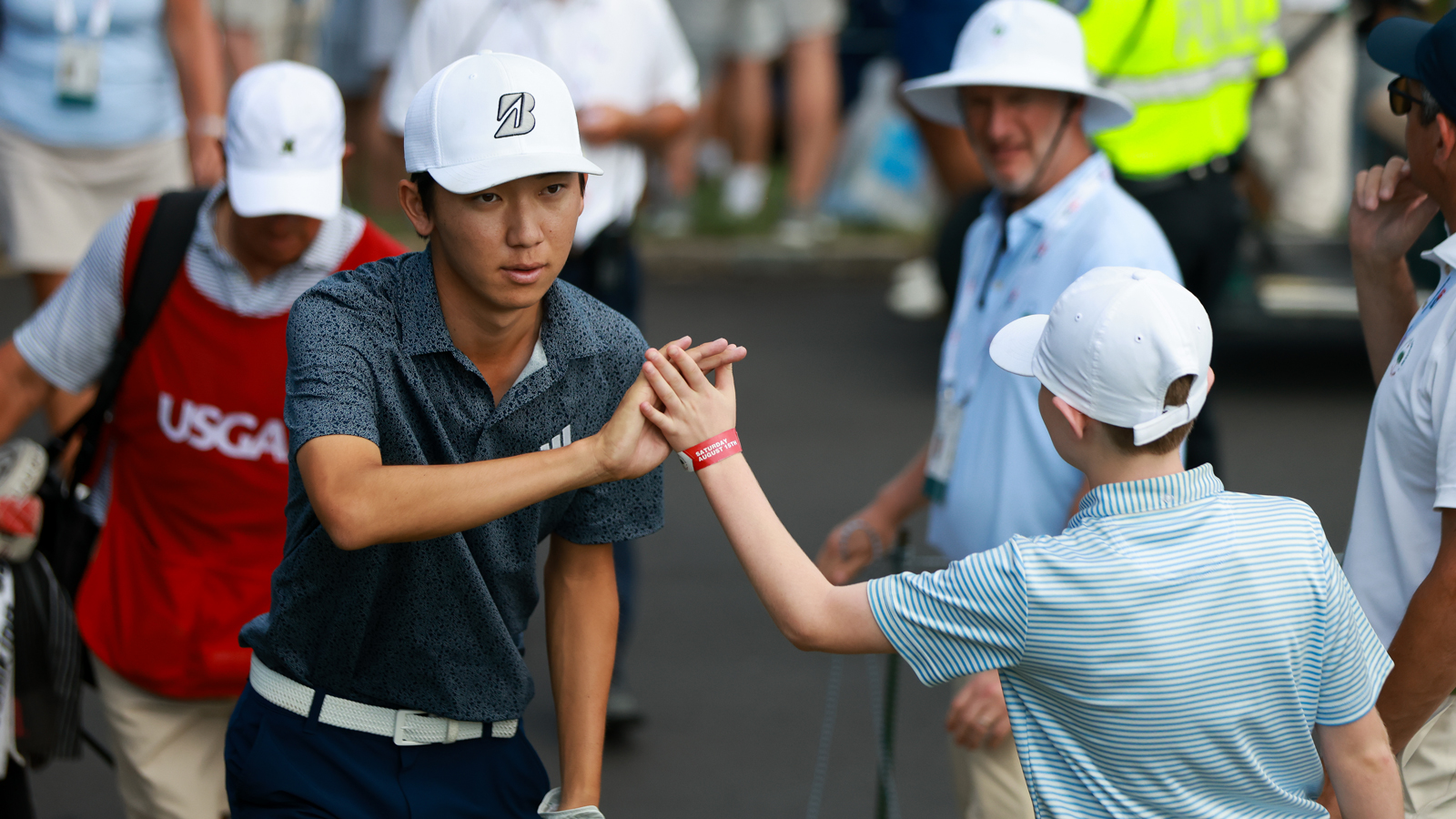 Jay Leng Jr high fives a fan