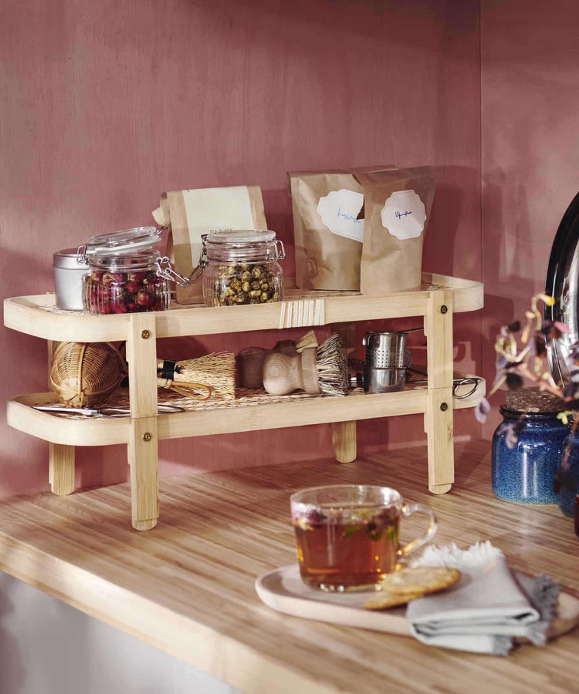 Cherry red kitchen with wooden sideboard and mini glass jars