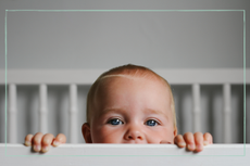 baby looking up in cot