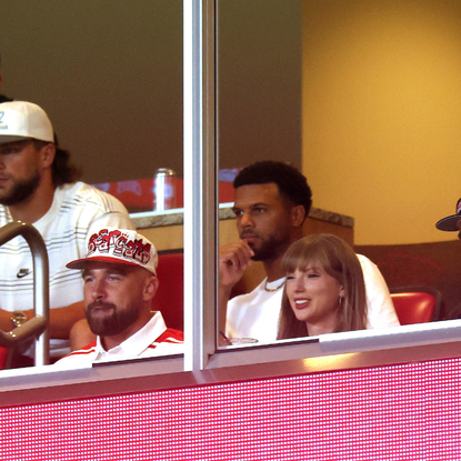 taylor swift and travis kelce in a football stadium box