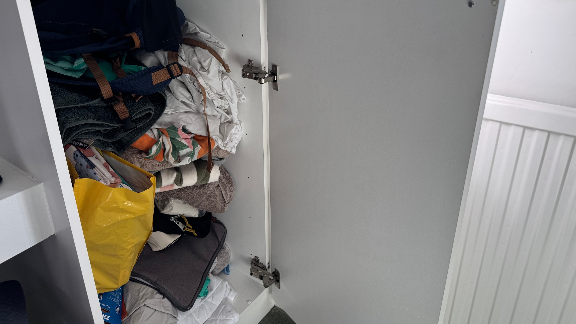 A pile of clothes, towels and bags