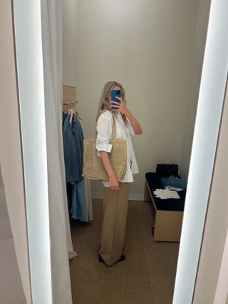 Photo of Eliza Huber in Madewell dressing room taking mirror selfie trying on clothes